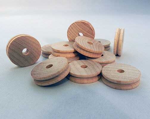 Wood pulleys are lighter and have a higher coefficient of friction than cast iron or steel pulleys.